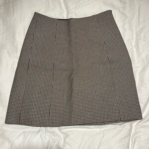 Tan/black/cream plaid skirt from Aritzia by Babaton.